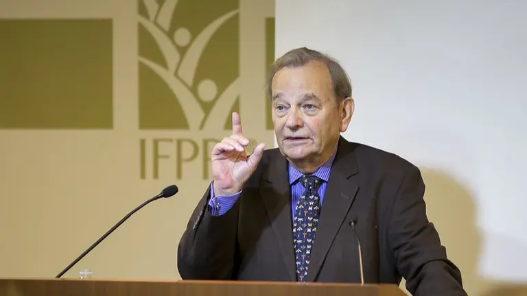 Gordon Conway speaking in front of a microphone.