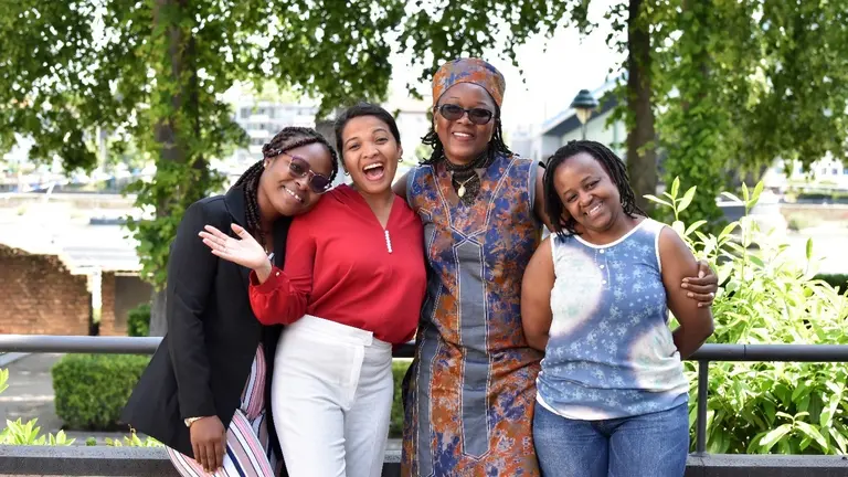 Four women smiling at the camera.
