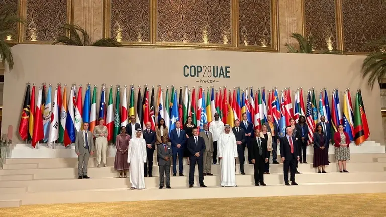 People posing in front of national flags.