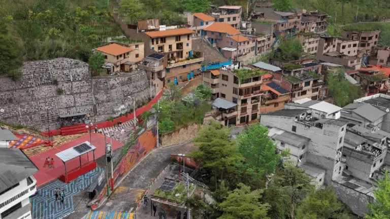 A city street with buildings on a hillside, showcasing the urban landscape.