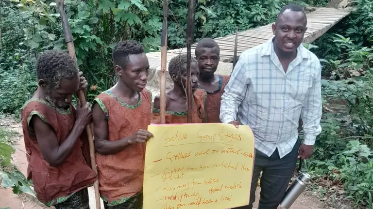 Five men holding a poster.