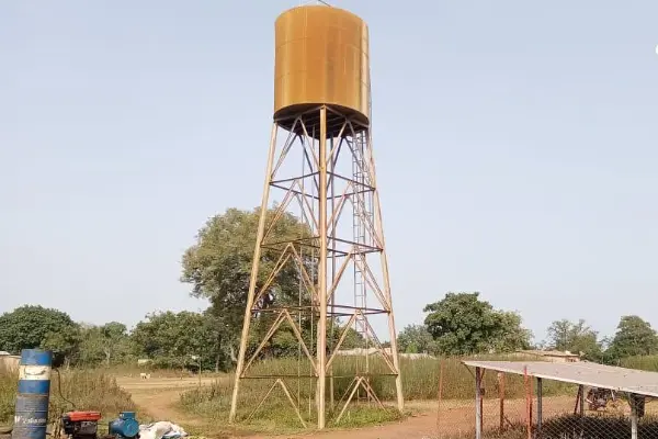 A water tower towers over the barren landscape.