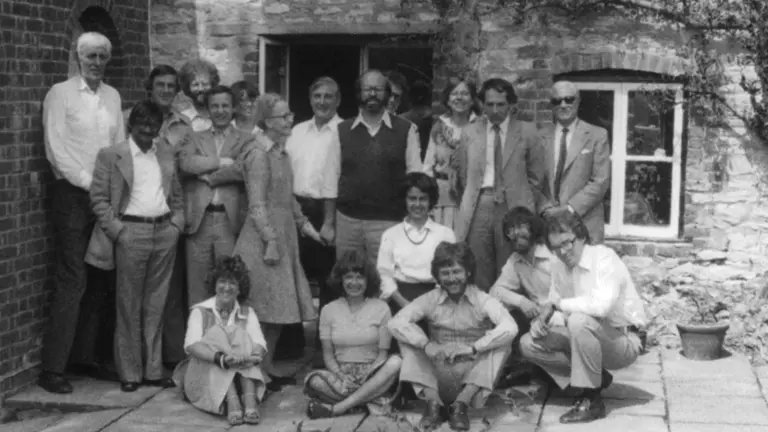 Black and white photo of Barbara Ward, David Satterthwaite and other IIED staff.