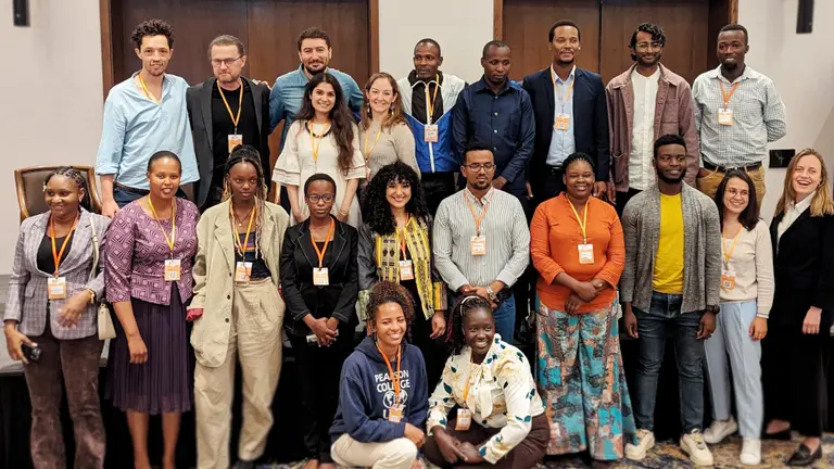 A group of people in three rows smiling.