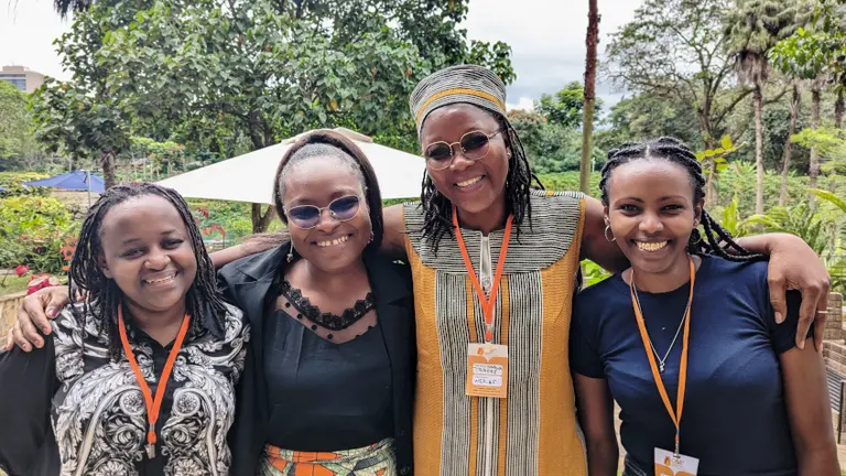 Four women smiling.