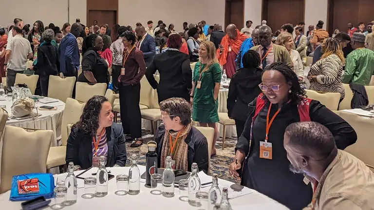 A large room with groups of people in conversation.