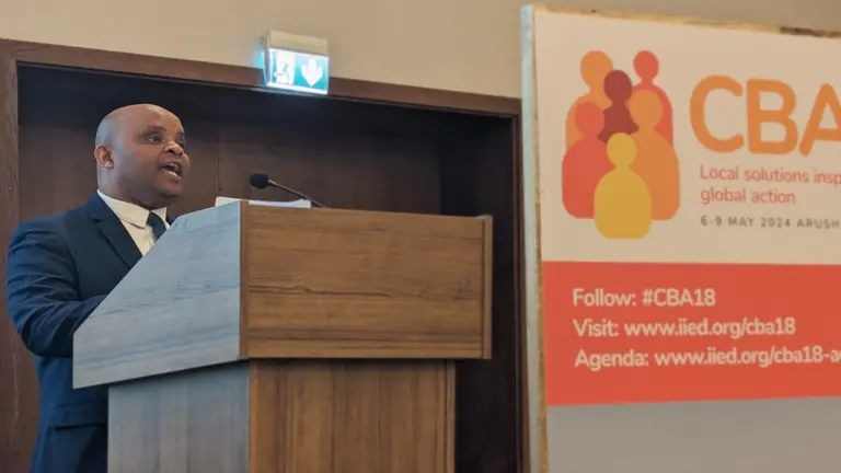  A man standing at a lectern speaking