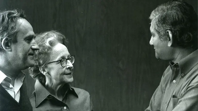 Two men and a woman in discussion.