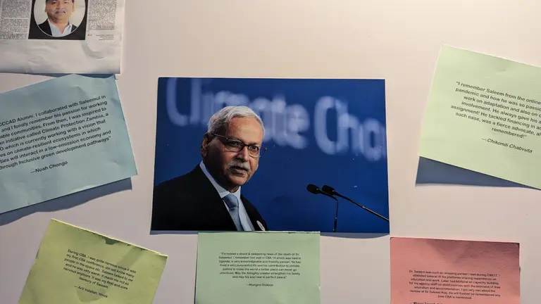 A photo of Saleem surrounded by pieces of paper.