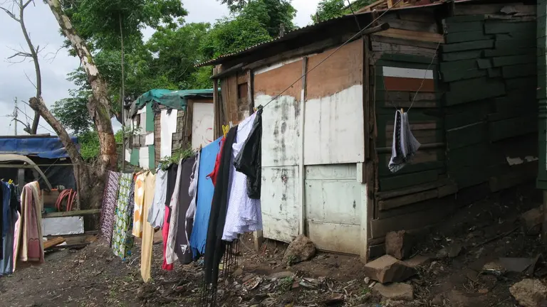 Washing blocks in informal settlements with clothes hang to dry outside.