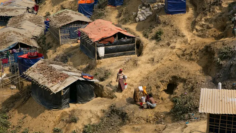 Women washing clothes in a refugee camp in Bangladesh
