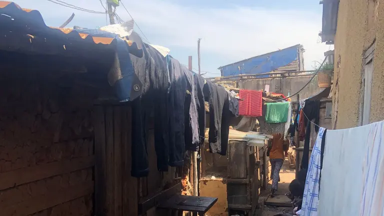 A corridor in Kisenyi, with a semi-permanent hostel and a permanent structure.