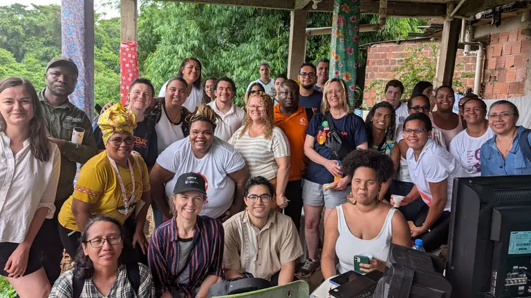 Group photo of participants gathered together, holding snacks.