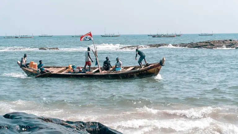 Boat of fisherman returning to shore in Ghana