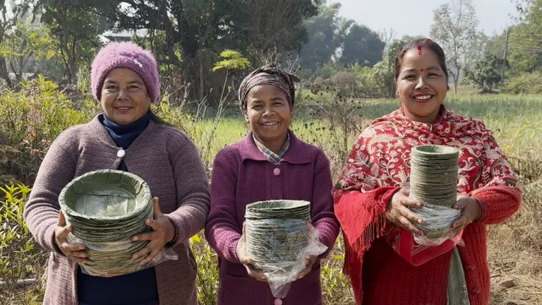 Women displaying their compressed Sal leaf plates.