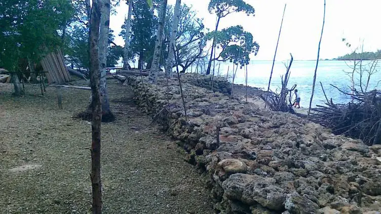 A brick wall separates the sea with land. 