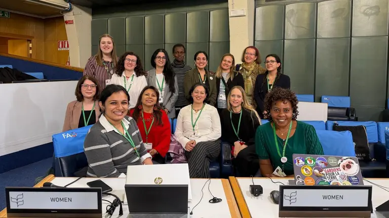 Group of women posing for a photograph inside the FAO building during the SBI-6 conference.