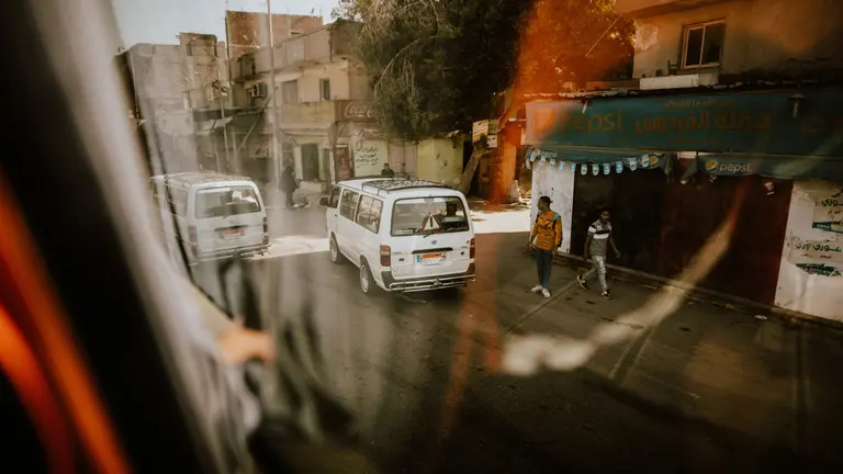 Minibuses on the streets of a busy city in Egypt. Bus drivers were among key groups affected by the subsidy reform because diesel prices.
