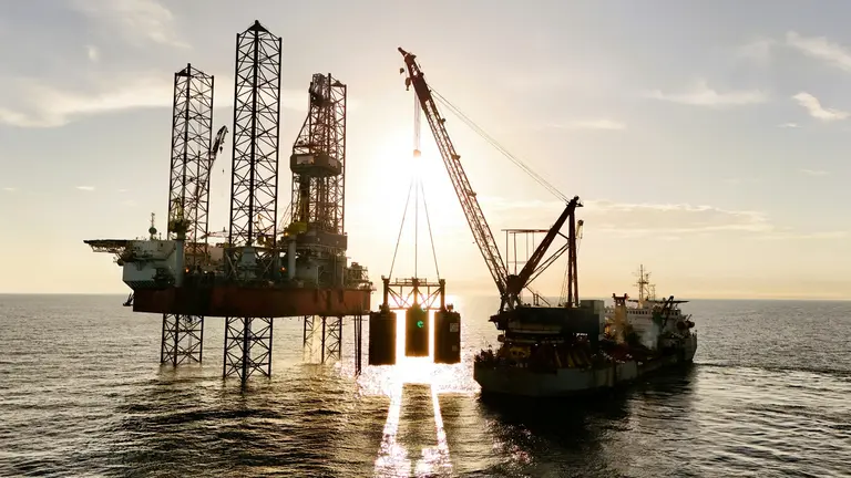 Oil rig being serviced by a supply ship in Mexico.