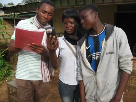 Youth and staff in Bamessing, Cameroon using a Garmin GPS unit to create a digital map of their community.