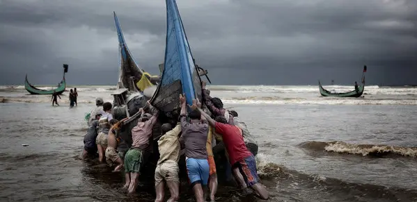 Fishing boats return to a beach on the Bay of Bengal. 
