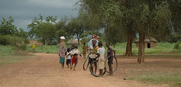 Children stand on a dirt road in a village in Burkina Faso. 