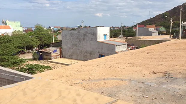 New construction sites for housing have been prepared by the government on the hillside above Nhon Hai, but the compensation isn't enough to let people move (Photo: David Dodman/IIED)
