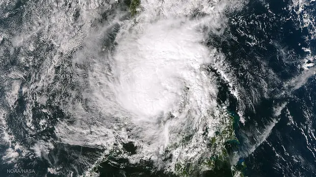 An image taken by NASA Goddard Space Flight Center shows Tropical Storm Hagupit weakening as it nears Manila, but it has already claimed 21 lives while COP20 proceeds in Lima (Photo: NASA/NOAA via NOAA Environmental Visualization Laboratory)