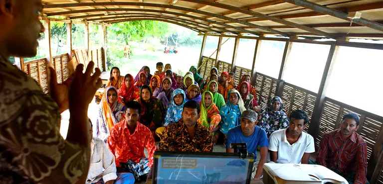A group meeting on climate change on boat run by the organisation Shidhulai in Natore, Bangladesh (Photo: Tony Stonehouse/IIED)
