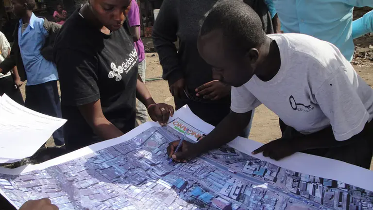 Surveying an aerial map of food safety threats in Mathare, an informal settlement in Nairobi Kenya (photo: Sohel Ahmed).