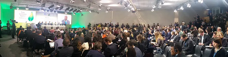 A packed room of journalists attend the High Ambition Coalition press conference