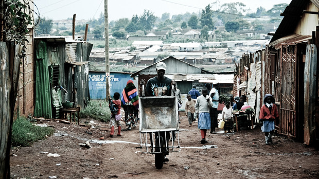 An image of a man with a wheelbarrow in the Kibera informal settlement in Nairobi, Kenya, the biggest in Africa and one of the biggest in the world. The rights of all must be incorporated into the 'new urban agenda' (Photo: Steffan Jensen/www.reversehomesickness.com, Creative Commons, via Flickr)