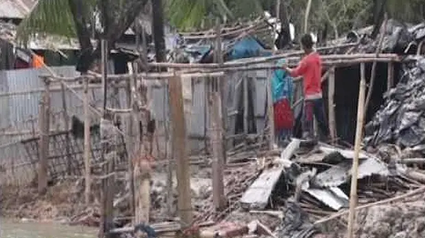 An image of television footage of a man standing instead a destroyed house after Cyclone Roanu hit Bangaldesh (Photo: Google licence)