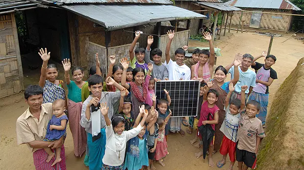 An image of villagers in a remote village in northern Bangladesh proudly displaying their first solar panel, purchased with a micro loan. Bangladesh aspires to be one of the world's largest solar providers (Photo: ILO in Asia and the Pacific, Creative Commons, via Flickr)