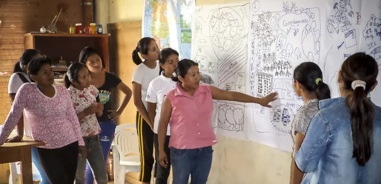 Women from Paraguay's Ita Guasu indigenous community discuss their community development plan. Civil debate and value-based decision making will be key to implementing the SDGs (Photo: USAID, Creative Commons via Flickr)