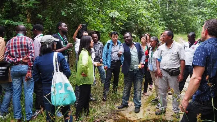 Patrice Kamkuimo (from Cerntre pour l'Environnement et le Developpement, Cameroon) explains to Xu Bin and others, the impacts on forest communities living near the soon to be inaugurated Deep Sea Port in Kribi, which is set to accelerate investment and trade in the country and region (Photo: Khanh Tran-Thanh/IIED)