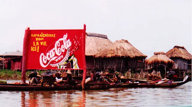 A Coca-Cola sign outside a small town in Benin. Bloomberg’s new health initiative will support cities to reduce the consumption of sugary drinks, but this isn't the biggest health challenge facing low-income urban residents (Photo: Lorena Pajares, Creative Commons via Flickr)