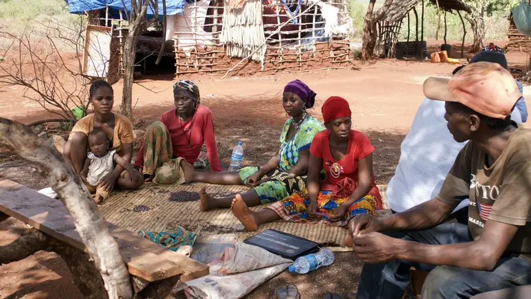Labourers gather at the 'camp area' at Rehema Peter's site