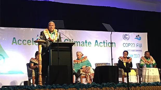 Fiji Prime Minister Frank Bainimarama speaks at the podium at the start of the pre-COP23 ministerial meeting. He called for a coalition of partners to reach 1.5 degrees (Photo: Achala Abeysinghe/IIED)