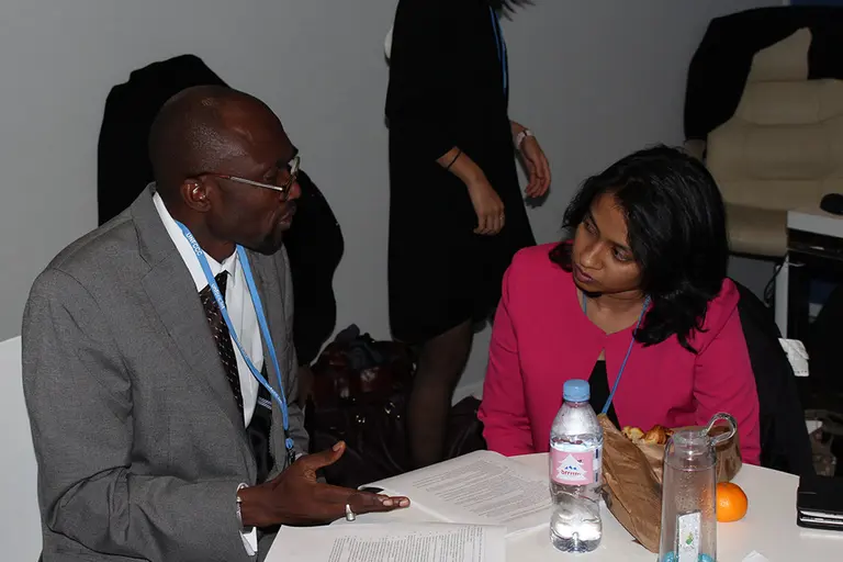 Pa Ousman Jarju, former chair of the LDC Group in the UNFCCC negotiations, confers with IIED's Achala C Abeysinghe at COP21, Paris