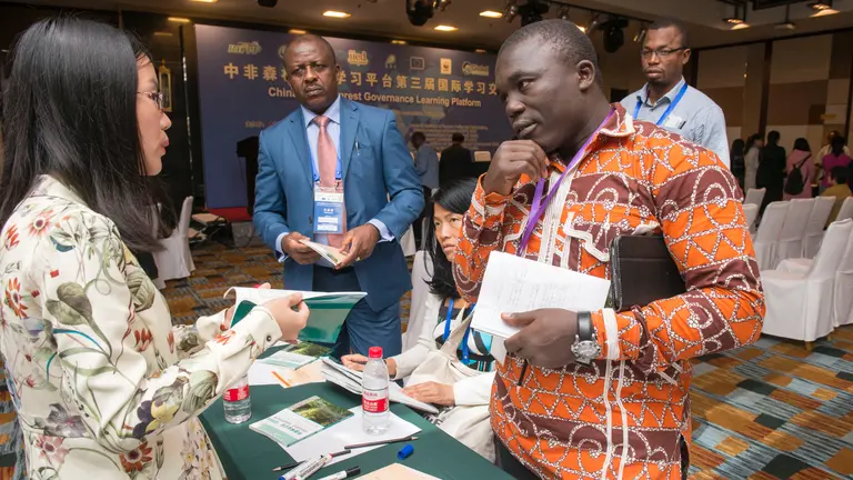 Li Ming and Teodyl Nkuintchua discus Chinese government guidelines