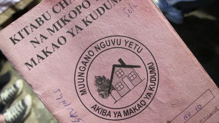 A daily savings book: local savings groups collect small payments from slum dwellers which can be leveraged to support slum upgrading projects (Photo: SDI, Creative Commons via Flickr)