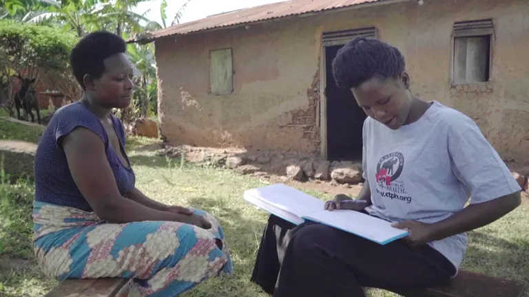 A volunteer conducting an interview outside