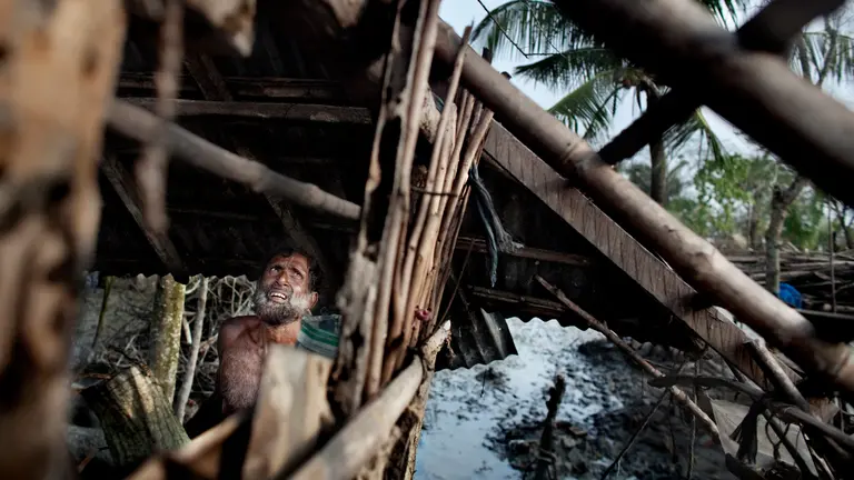 A man looking up at a partially constructed roof