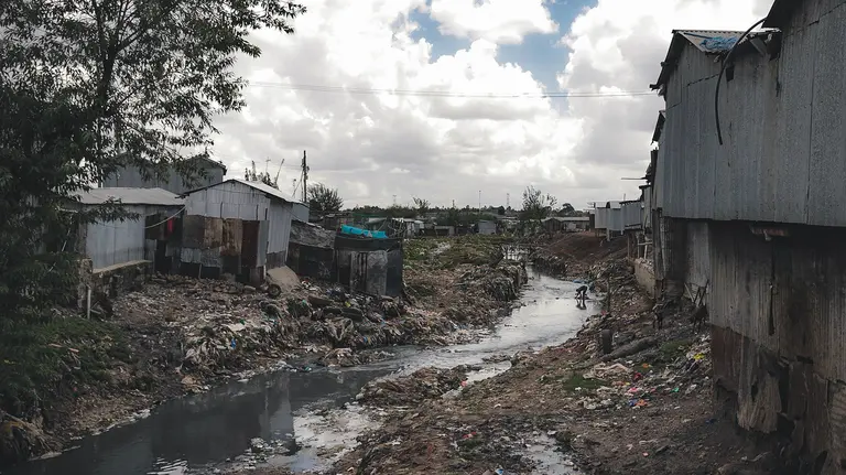 Water with open sewage is stagnant in a built up area