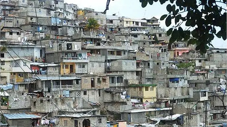 A view from distance of dozens of buildings in close proximity on a hill 