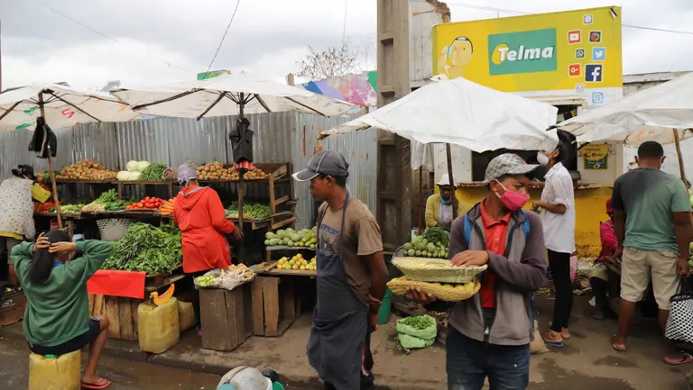 Market traders wearing face masks sell produce