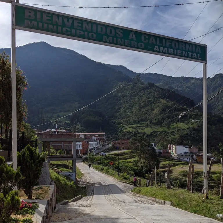 Photo of California, signpost reads “Welcome to California, a mining-environmental municipality”