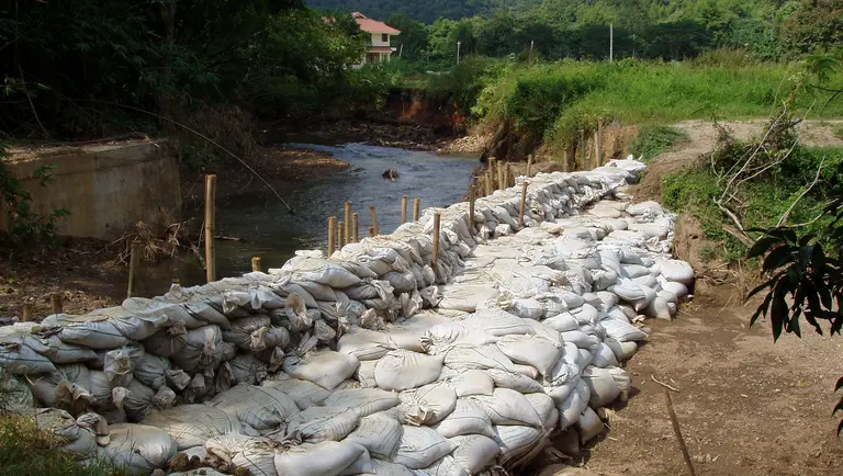 sandbags holding back river water