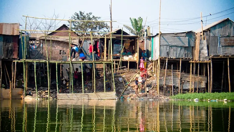 Stilt houses tower above water.